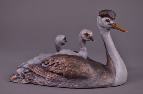 A bronze sculpture by Jim Green of a family of Clark's Grebes
