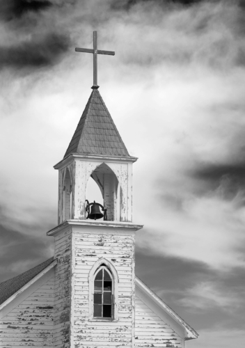 This photograph was taken by Amy Lehman. It is a black and white photo of an abandoned church in western South Dakota. It shows the promise of faith from a time long ago.
